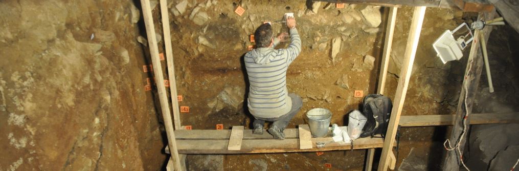 inders University Associate Professor Mike Morley sampling at the base of the cultural sequence in the East Chamber of Denisova Cave in 2014.