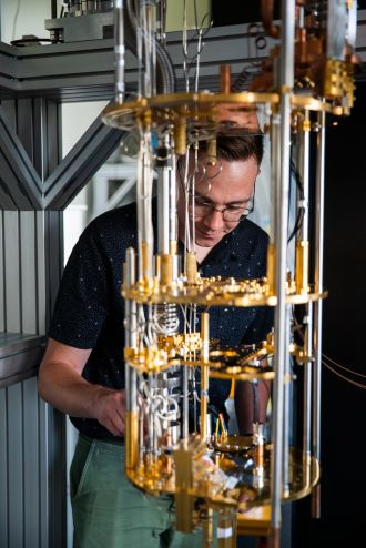 PhD student Wyatt Vine with quantum tower at UNSW's quantum labs