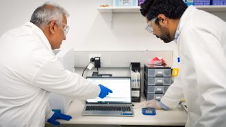 CSIRO researchers Gunjan Pandey and Rahul Rane reviewing data