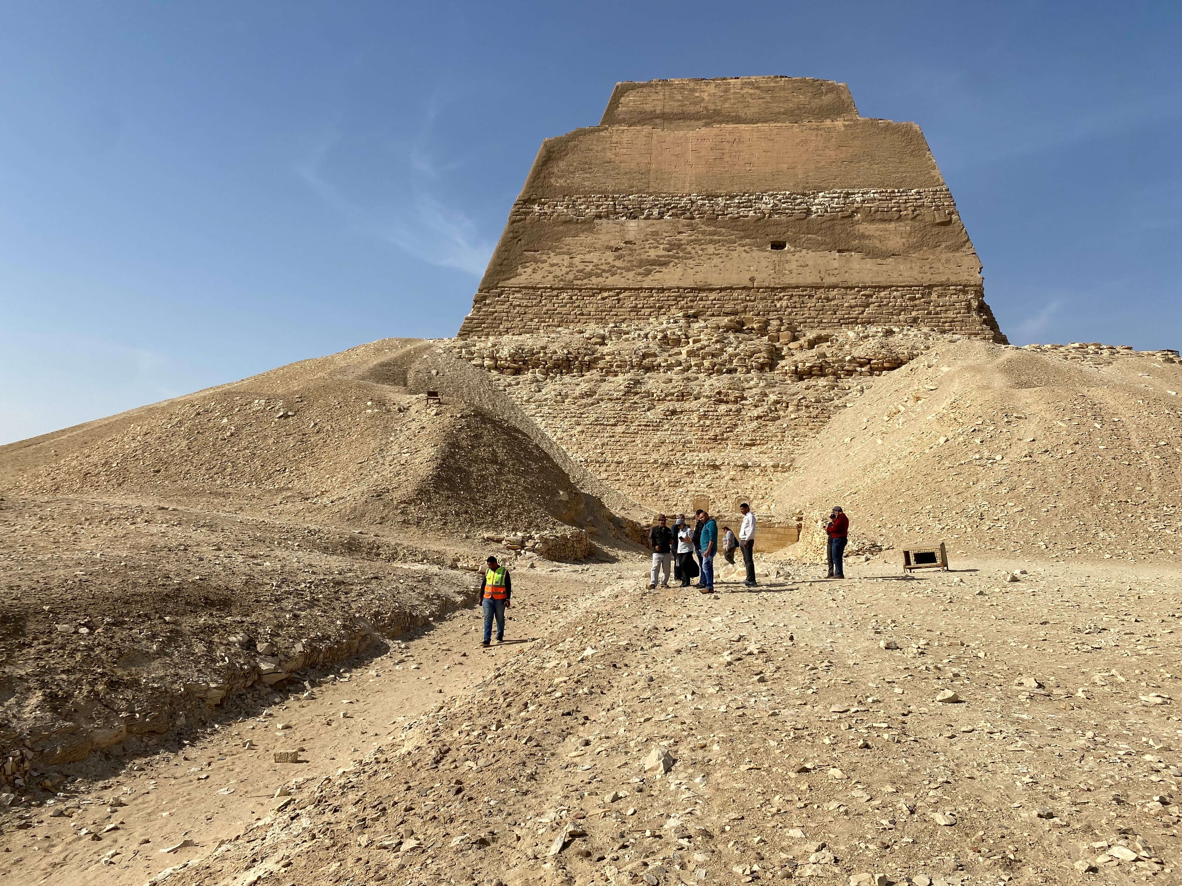 Photo courtesy UNCW Professor Eman Ghoneim. Caption: Dr Tim Ralph from Macquarie University at the Meidum Pyramid complex with colleagues from a multi-institution project during 2022.
