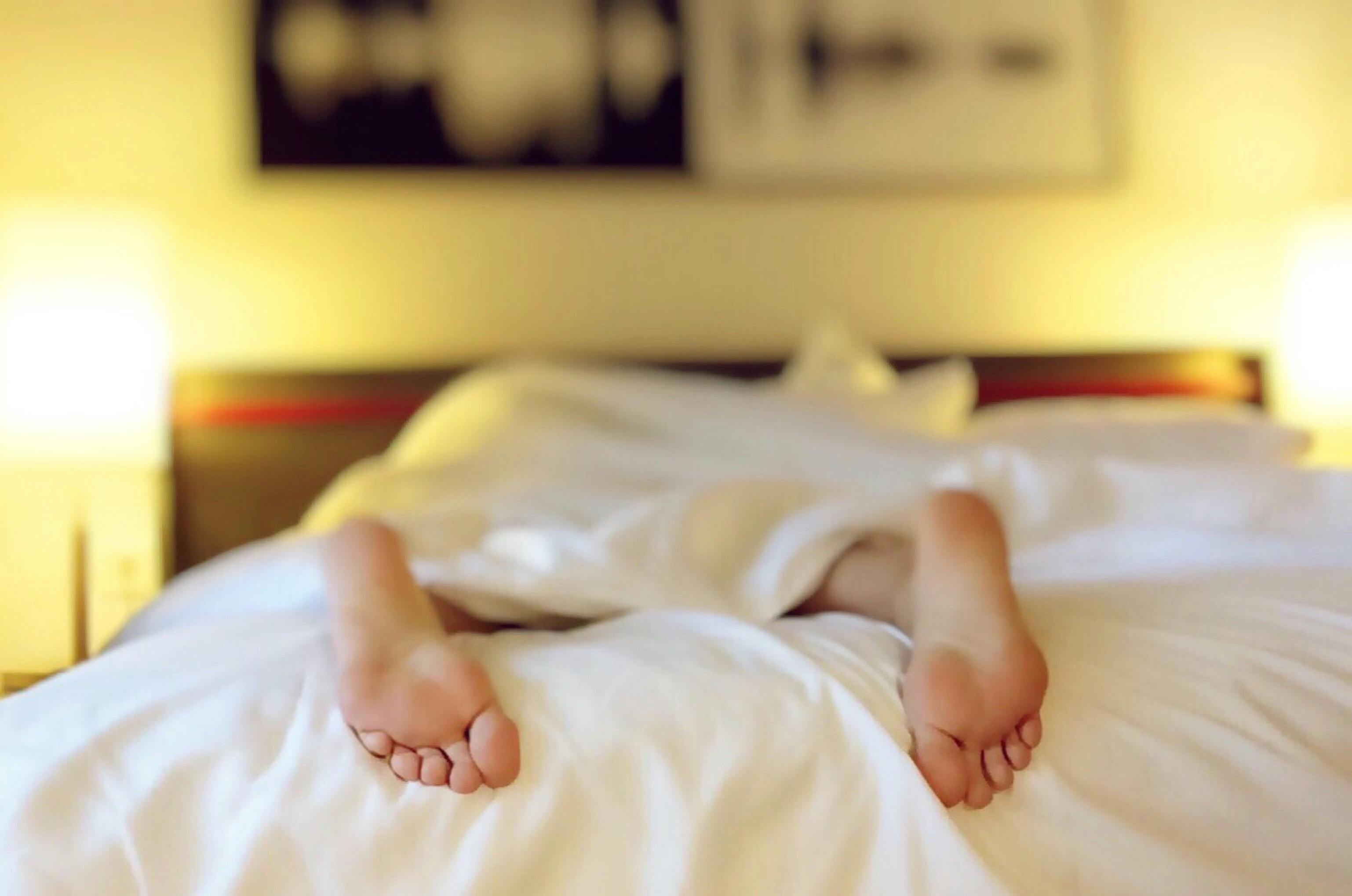 CC-0. https://www.pexels.com/photo/person-lying-on-bed-covering-white-blanket-271897/