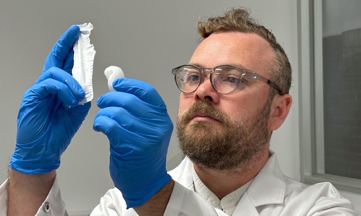 Dr Peter Sherrell from RMIT University with the static electricity invention (left) and polystyrene packing foam that it is made from. Credit: Seamus Daniel, RMIT University 