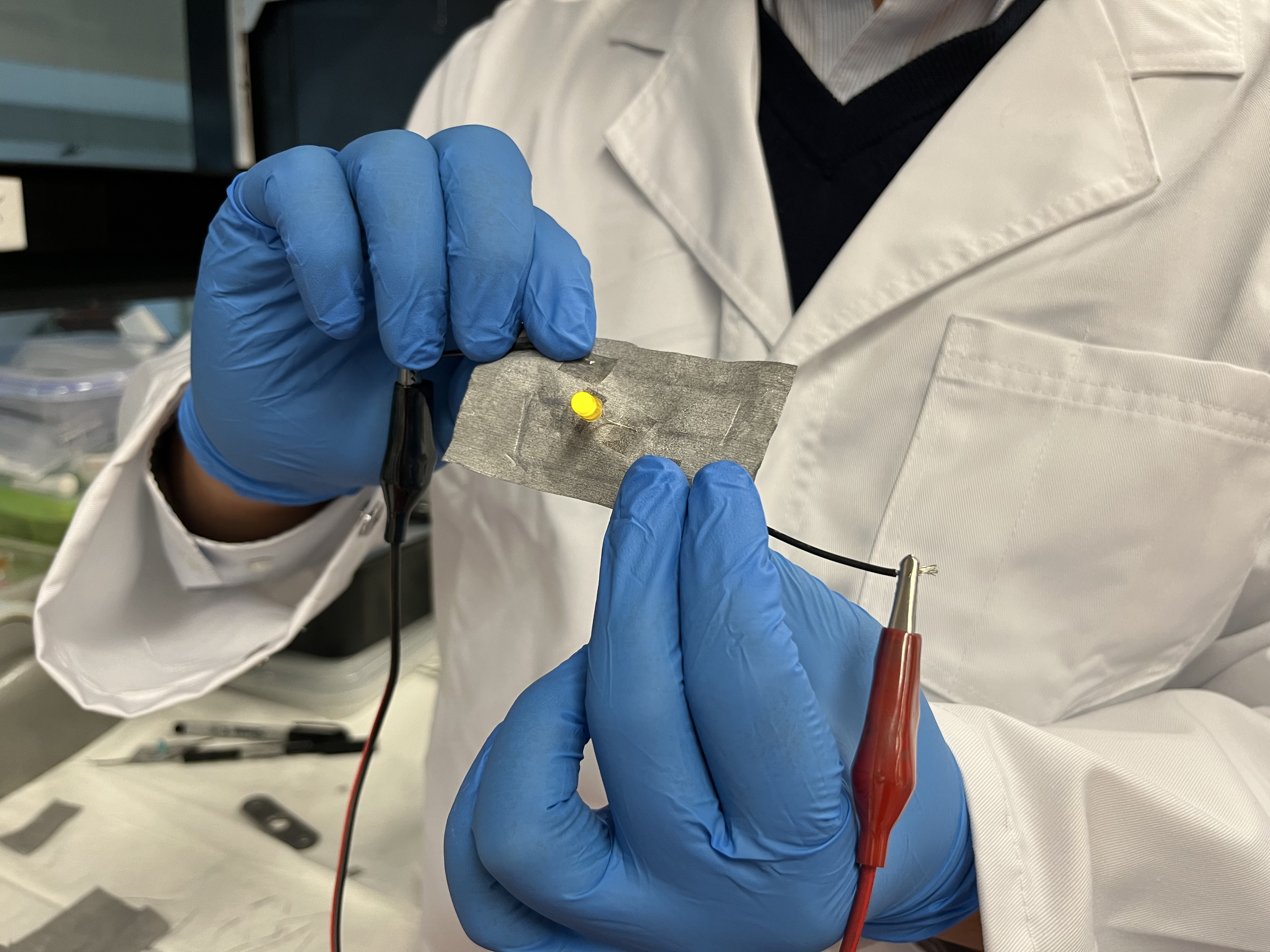  Close-up of the treated material being tested for its conductivity under various stresses. 