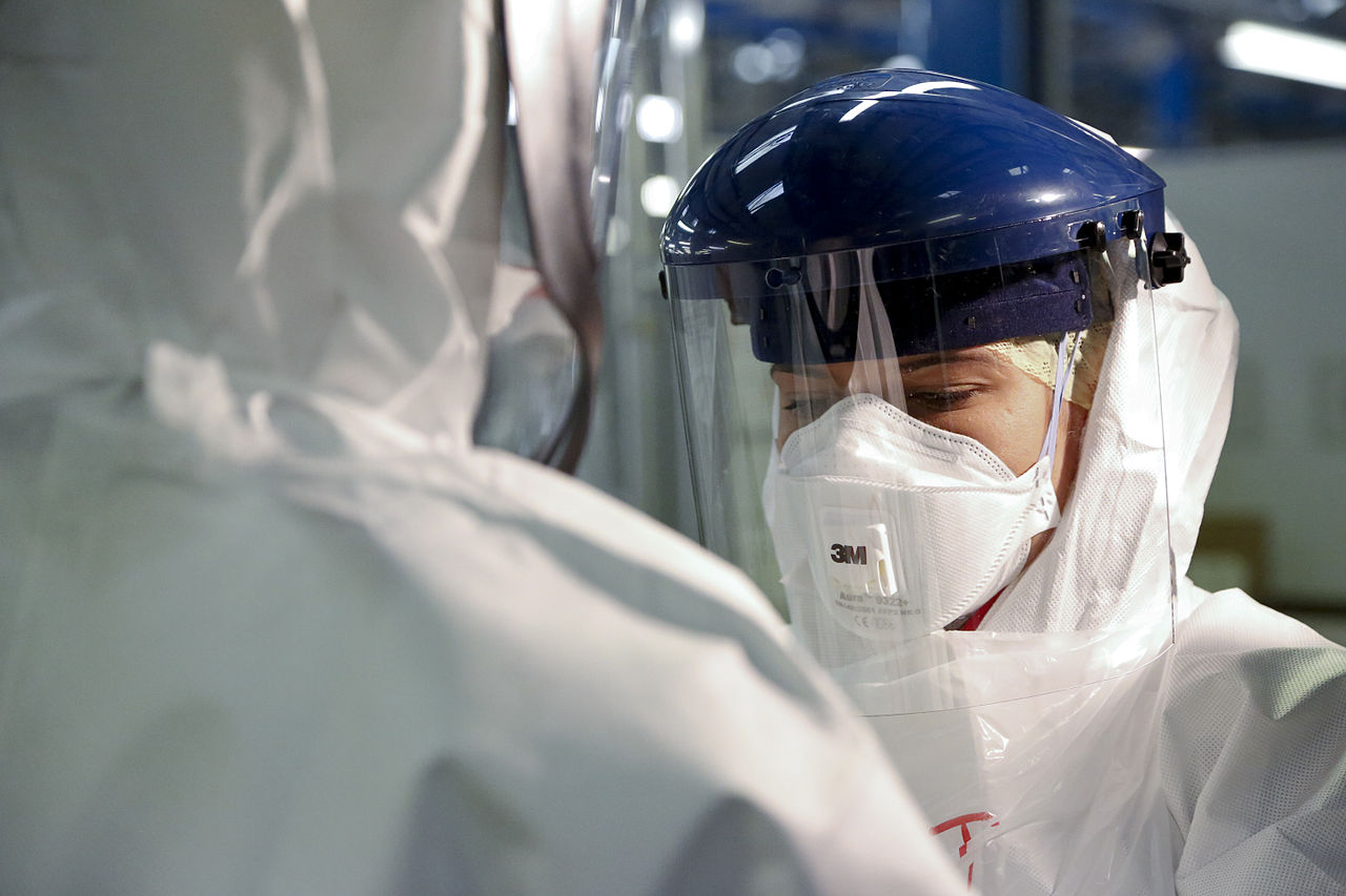 By DFID - UK Department for International Development - Checking Personal Protective Equipment (PPE) in the fight against Ebola, CC BY 2.0