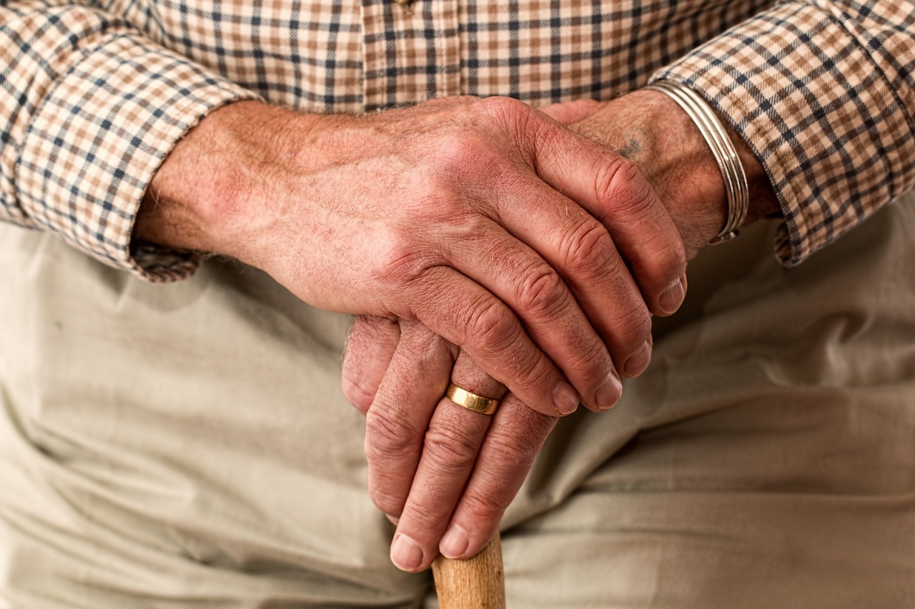 CC-0. https://pixabay.com/photos/elderly-hands-ring-walking-stick-981400/